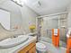 Well-lit bathroom featuring modern fixtures, shower with glass door and bright tiles at 565 Sutton Place, Longboat Key, FL 34228