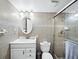 Bright bathroom with a tiled shower, glass door, and stylish vanity at 565 Sutton Place, Longboat Key, FL 34228