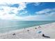 Scenic beach view showcasing blue skies, turquoise waters, and pristine white sand, perfect for relaxation at 565 Sutton Place, Longboat Key, FL 34228