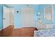 Serene bedroom with blue walls, a large closet, and a stylish dresser at 565 Sutton Place, Longboat Key, FL 34228