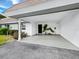 Spacious carport features a well maintained floor and tropical accents at 565 Sutton Place, Longboat Key, FL 34228