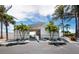 Beach entrance with a covered area for picnic tables and beautiful palm trees at 565 Sutton Place, Longboat Key, FL 34228