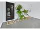 The front entrance includes decorative plants and a secure screen door at 565 Sutton Place, Longboat Key, FL 34228