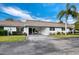 Charming home with fresh paint, well maintained lawn and landscaping, and covered parking at 565 Sutton Place, Longboat Key, FL 34228