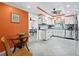 Well-lit kitchen featuring white cabinets, stainless steel appliances, and an adjacent dining area at 565 Sutton Place, Longboat Key, FL 34228