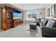 Living room featuring comfortable seating, a large television, and tiled floors at 565 Sutton Place, Longboat Key, FL 34228