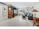 Living room featuring comfortable seating, a large television, and tiled floors at 565 Sutton Place, Longboat Key, FL 34228