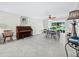Bright, open-plan living space features tiled floors and a serene garden view at 565 Sutton Place, Longboat Key, FL 34228