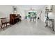 Bright, open-plan living space features tiled floors and a serene garden view at 565 Sutton Place, Longboat Key, FL 34228