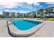 Community pool surrounded by lounge chairs for relaxation at these gorgeous condominiums, perfect for hot summer days at 565 Sutton Place, Longboat Key, FL 34228