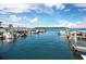 View of a waterfront with docks available for boat parking surrounded by stunning blue skies and serene ocean waters at 565 Sutton Place, Longboat Key, FL 34228