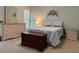 Cozy bedroom featuring a comfortable bed, wicker furniture, and soothing decor at 5657 Westwind Ln, Sarasota, FL 34231