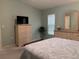 Well-lit bedroom with wicker dressers, soothing color scheme, and comfortable furnishings at 5657 Westwind Ln, Sarasota, FL 34231