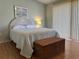 Bedroom with hardwood floor, a comfortable bed, chest and bright natural light at 5657 Westwind Ln, Sarasota, FL 34231