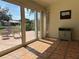 Light-filled sunroom featuring a large sliding glass door with a view of the beautiful backyard at 5657 Westwind Ln, Sarasota, FL 34231