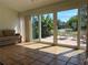 Bright sunroom with tile floors and sliding glass doors opening to a patio and backyard at 5657 Westwind Ln, Sarasota, FL 34231