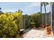 Private patio area with lush greenery and potted plants at 600 Manatee Ave # 111, Holmes Beach, FL 34217