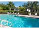 Sparkling community pool surrounded by lounge chairs and lush landscaping, perfect for relaxation at 600 Manatee Ave # 111, Holmes Beach, FL 34217