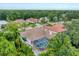 Aerial view of a residential neighborhood with lush trees, highlighting the home's private backyard pool at 6620 Saint James Xing, University Park, FL 34201