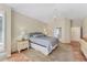 Comfortable bedroom featuring tile flooring, a ceiling fan, and an ensuite bathroom at 6620 Saint James Xing, University Park, FL 34201