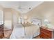 Bedroom with tile flooring, ceiling fan, and side tables with lamps at 6620 Saint James Xing, University Park, FL 34201