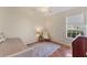 Small bedroom featuring tile flooring, chair, daybed, and a window with blinds at 6620 Saint James Xing, University Park, FL 34201