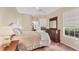 Bedroom featuring tile flooring, a dresser, and a window with blinds at 6620 Saint James Xing, University Park, FL 34201