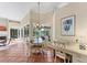 Inviting breakfast nook with backyard and pool views, adjacent to an outdoor fireplace and tiled flooring at 6620 Saint James Xing, University Park, FL 34201