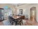Formal dining room with tile flooring, large windows, chandelier, and dining set with seating for six at 6620 Saint James Xing, University Park, FL 34201