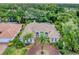 Stunning aerial view of a tile-roof home with a circular driveway and lush landscaping at 6620 Saint James Xing, University Park, FL 34201