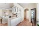 Bright kitchen with adjacent dry bar and glass-front cabinetry provides great storage and entertainment features at 6620 Saint James Xing, University Park, FL 34201