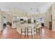 Bright kitchen features a spacious island with seating, white cabinets, and modern stainless steel appliances at 6620 Saint James Xing, University Park, FL 34201