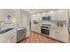 Kitchen features white cabinets, modern appliances, and plenty of counter space for cooking and meal preparation at 6620 Saint James Xing, University Park, FL 34201