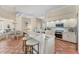 Bright eat-in kitchen features an island with bar seating, white cabinets, and modern stainless steel appliances at 6620 Saint James Xing, University Park, FL 34201