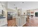Spacious kitchen features a large island, stainless steel appliances, and an open view into the living room at 6620 Saint James Xing, University Park, FL 34201