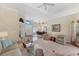 Inviting living room with a ceiling fan, a large window, and an open view to the dining room at 6620 Saint James Xing, University Park, FL 34201