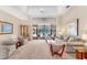 A bright living room with high ceilings that leads to a screened-in porch and pool area at 6620 Saint James Xing, University Park, FL 34201