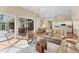 Inviting living room featuring neutral tones, tile flooring, and seamless access to outdoor patio at 6620 Saint James Xing, University Park, FL 34201