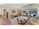Spacious living room with access to the pool, tile flooring, and stylish, neutral-toned furniture at 6620 Saint James Xing, University Park, FL 34201