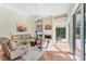 Comfortable living room with a fireplace, built-in shelving, and access to the outdoor screened-in patio and pool at 6620 Saint James Xing, University Park, FL 34201