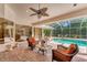 Screened pool area with comfortable seating and lush landscaping, perfect for enjoying outdoor living at 6620 Saint James Xing, University Park, FL 34201