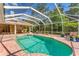 Lush landscaping surrounds an inviting backyard pool and screened patio, creating a serene outdoor oasis at 6620 Saint James Xing, University Park, FL 34201