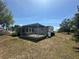 Backyard features a screened porch, great for outdoor lounging and complemented by a well-maintained yard at 6882 Holo Ct, North Port, FL 34287