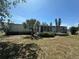 Rear view of the property featuring a screened lanai, offering an ideal space for outdoor enjoyment and shade at 6882 Holo Ct, North Port, FL 34287