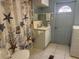 A serene bathroom with a seashell-themed shower curtain and a sink with ample counter space at 6882 Holo Ct, North Port, FL 34287