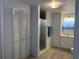 Bathroom with white cabinets, shower, toilet, sink, and wood grain vinyl flooring at 6882 Holo Ct, North Port, FL 34287
