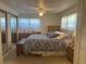 Cozy bedroom featuring a ceiling fan, carpet, and a comfortable bed with wooden furniture at 6882 Holo Ct, North Port, FL 34287