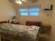 Cozy bedroom with a bright window and comfortable bed, dresser and night stand at 6882 Holo Ct, North Port, FL 34287