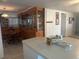 Bright dining area with a large wood china cabinet and an adjacent kitchen with an island at 6882 Holo Ct, North Port, FL 34287