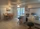 Open-concept room with eat-in kitchen flowing into dining area, complete with tile flooring at 6882 Holo Ct, North Port, FL 34287